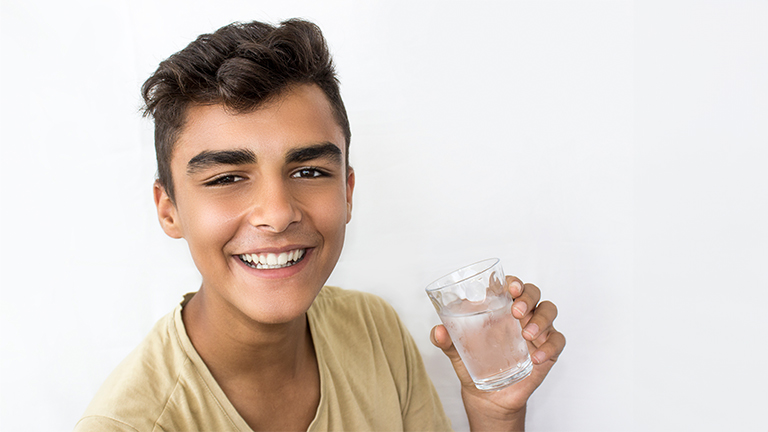 Teenager drinking water.