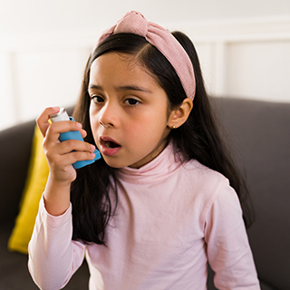 Young girl with an asthma inhaler.
